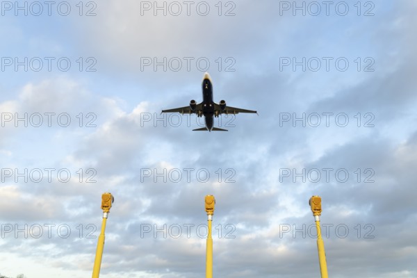 Boeing 737 commercial passenger airliner jet aircraft of Ryanair airways in flight on approach to land over runway lights at London Stansted airport, Essex, England, United Kingdom