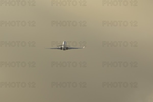 Gulfstream executive business jet aircraft in flight at sunset at London Stansted airport, Essex, England, United Kingdom