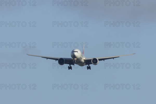 Boeing 777 commercial passenger airliner jet aircraft of Emirates airways in flight on approach to Stansted airport, Essex, England, United Kingdom