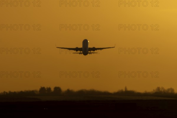Airbus commercial passenger airliner jet aircraft taking off in flight at sunset at London Stansted airport, Essex, England, United Kingdom