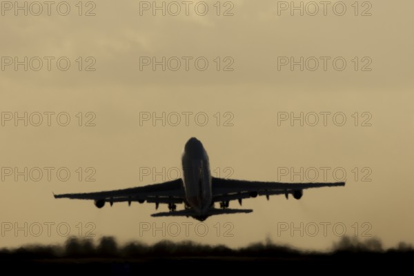 Boeing 747-400 jumbo jet LX-TCV commercial aircraft of Cargolux cargo taking off in flight silhouette at sunset at London Stansted airport, Essex, England, United Kingdom