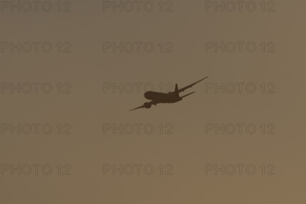 Boeing 777 A7-BFL commercial jet aircraft of Qatar cargo in flight silhouette at sunset at London Stansted airport, Essex, England, United Kingdom