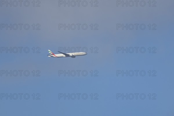Boeing 777 commercial passenger airliner jet aircraft of Emirates airways in flight at London Stansted airport, Essex, England, United Kingdom