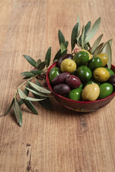 A mixture of olives, varieties of chalkidiki, Verdi giganti and Kalamata, in a bowl, top view, no people