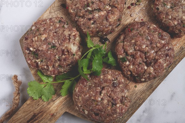 Raw cutlets, minced meat, on a chopping board, homemade, top view, no people