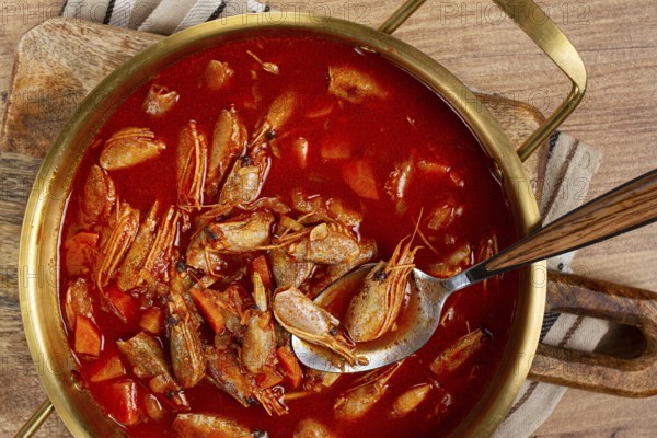 French shrimp bisque soup, in a pot, close-up, no people