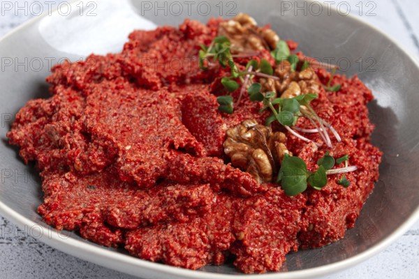 Mahammara red pepper sauce, with walnuts, and sprigs of fresh microgreens, homemade, no people