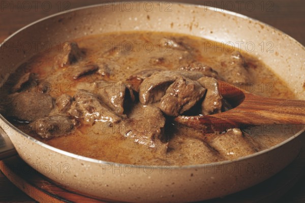 Beef stroganoff, pan cooking, close-up, homemade