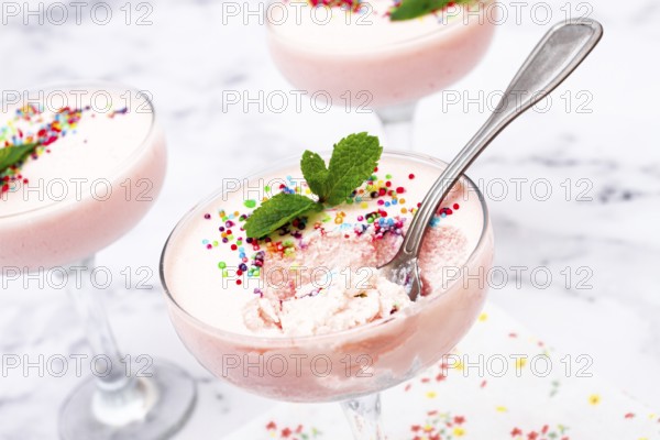 Fruit mousse, made from jelly and cottage cheese, in glasses, decorated with sprinkles and mint, homemade