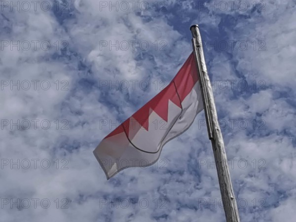 Franconian flag, red and white flag blowing in the wind against a slightly cloudy sky, Upper Franconia