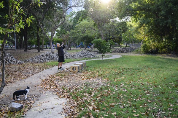 Bangkok, Thailand. March 4th 2025. A local man does some warm up stretches and exercises to keep fit in Lumphini Park, Bangkok, Thailand