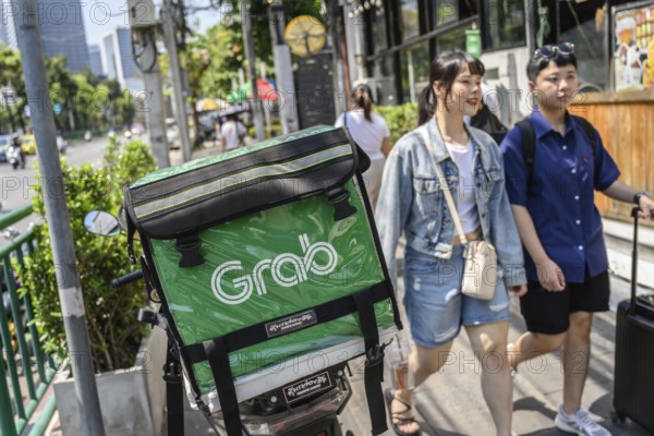 Bangkok, Thailand. March 25th 2025. Grab food delivery motorcycles parked in the busy streets of Bangkok business district, Thailand, Asia