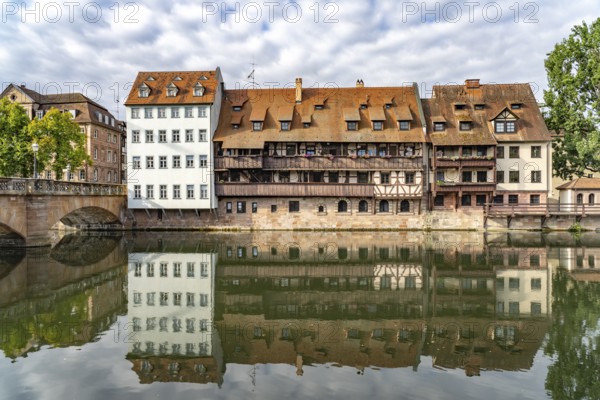 Houses in the old town are reflected in Pegnitz, Nuremberg, Bavaria, Germany