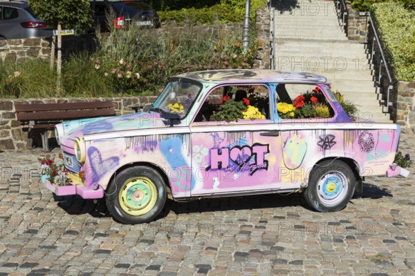 Colourfully painted and planted Trabant car on the old market in Hohenstein-Ernstthal, Saxony, Germany