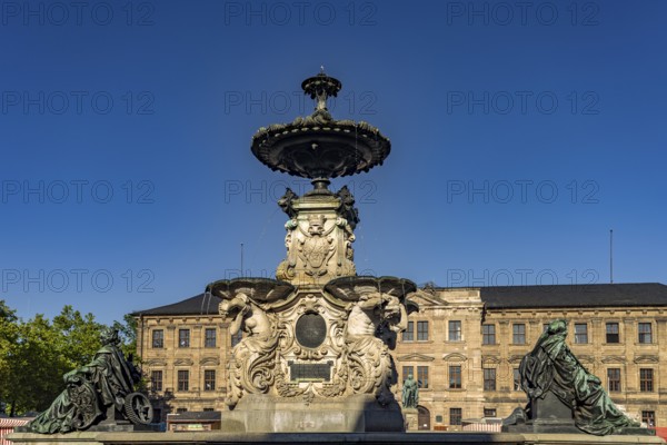 The Paulibrunnen on the market square and the castle in Erlangen, Middle Franconia, Bavaria, Germany