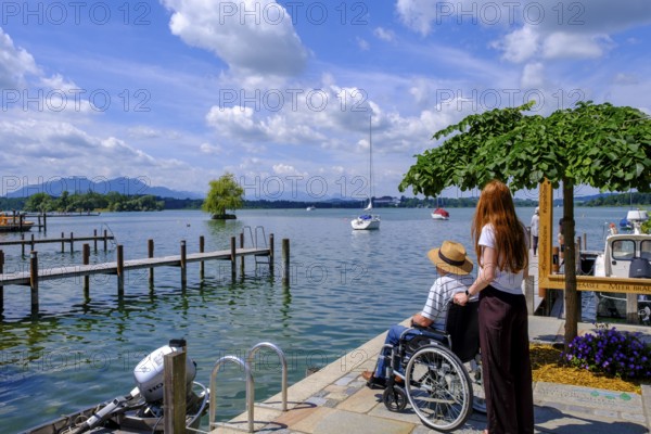 Strollers with wheelchair, Fraueninsel, Chiemsee, Chiemgau, Upper Bavaria, Bavaria, Germany