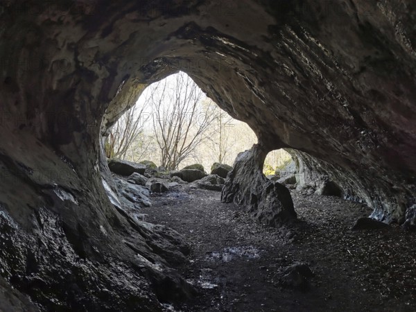 View from a mystical cave, with uneven rocks inside, Quack Castle, Franconian Switzerland, Upper Franconia