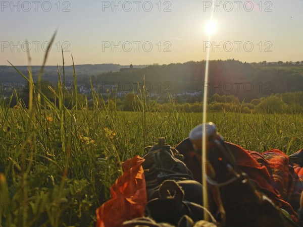 A picnic in a meadow as the sun sets and a panoramic view of the Rosenberg Fortress, Kronach, Frankenwald nature park Park