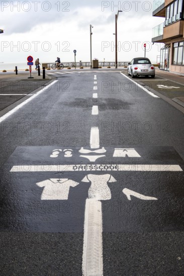 Winter break, on the Zeedijk-Knokke, beach promenade in Knokke-Heist, commandment sign, prohibition sign, for the dress code on the North Sea beach and in the city, painted on the road surface, dreary winter day, Belgium