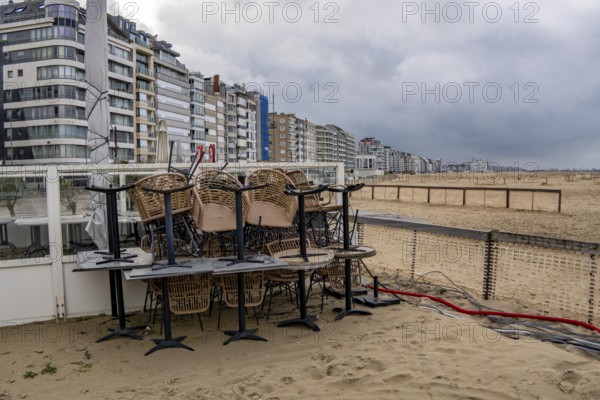 Winter break, closed terraces of catering establishments on Zeedijk-Knokke, beach promenade in Knokke-Heist, on the North Sea beach, dreary winter day, mostly apartment buildings with rental or condominiums, high-rise buildings on the street, Belgium