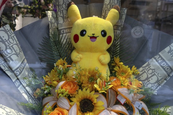 Yellow Pikatchu, Pokémon, fictional character of a video game in a shop window, Bavaria, Germany