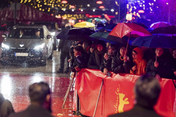 Fans in the rain with umbrellas at the opening of the Berlinale at the Theater am Potsdamer Platz in Berlin on 12.02.2026. The 76th Berlin International Film Festival will take place from February 12 to 22, 2026