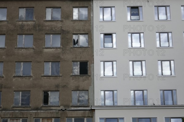 Prora, district of the municipality of Binz on Prorer Wiek. Former Kraft durch Freude (KdF) seaside resort on Rügen. Built during the National Socialist era. The Colossus of Rügen is being converted into holiday flats. Renovated on the right. On the left, the old dilapidated building. Island of Rügen, largest and most populous German island, Baltic Sea coast, Baltic Sea, Mecklenburg-Western Pomerania, Germany, Northern Europe