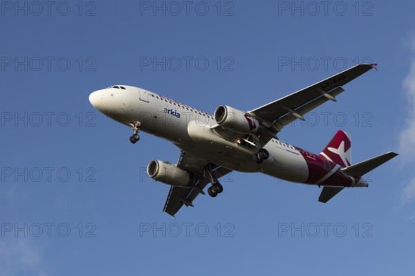 Airbus A320 commercial passenger airliner jet aircraft of Electra airlines flying on approach to land at London Stansted airport, Essex, England, United Kingdom