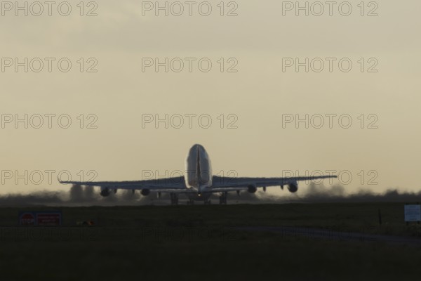Boeing 747-400 jumbo jet LX-TCV commercial aircraft of Cargolux cargo taking off in flight silhouette at sunset at London Stansted airport, Essex, England, United Kingdom