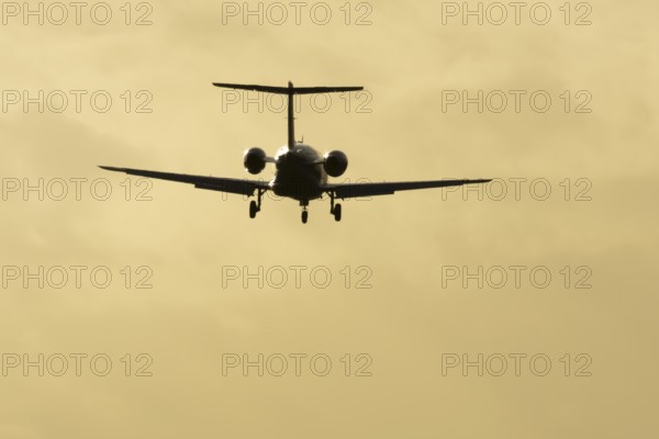 Cessna Citation small executive business jet aircraft in flight on approach to land at sunset at London Stansted airport, Essex, England, United Kingdom