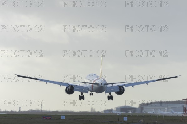 Boeing 777 commercial passenger airliner jet aircraft of Emirates airways landing on the runway at London Stansted airport, Essex, England, United Kingdom