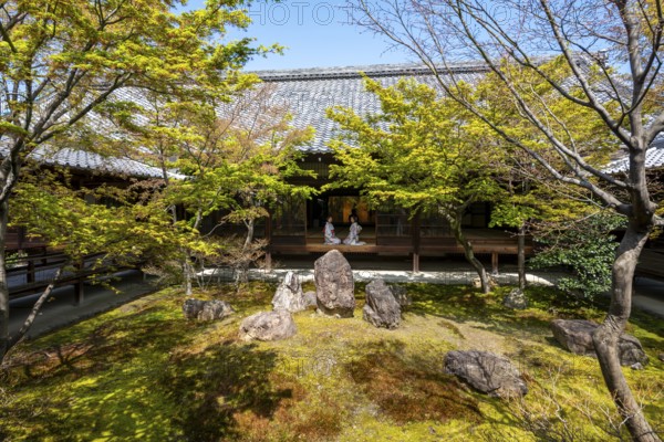 Two Japanese woman dressed in kimono sitting at an open door, O-shoin courtyard with Shione Garden, Kennin-ji Temple, Higashiyama, Kyoto, Japan