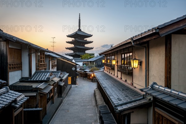 Yasaka dori historic street in the old town with traditional Japanese houses, five-story Yasaka Pagoda of the Buddhist Hokanji Temple at the back, evening mood, sunset, Higashiyama, Kyoto, Japan