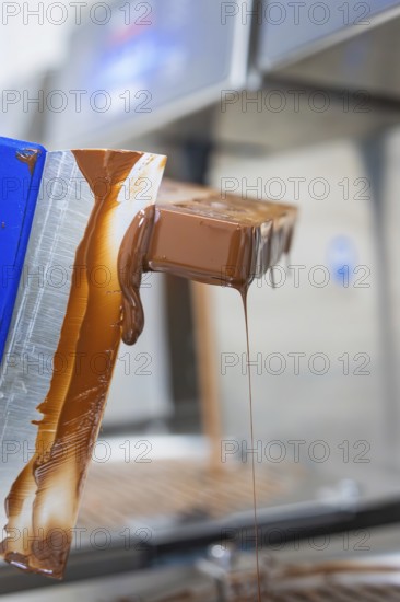 Flowing chocolate from a chocolate mold, vegan chocolates production, Haselstaller Hof, Gechingen, Germany