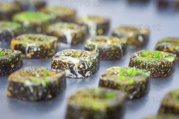 Series of decorated chocolates with artistic colorful patterns, vegan chocolates production, Haselstaller Hof, Gechingen, Germany