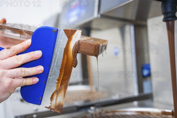 Side view of a flowing chocolate mold, vegan chocolates production, Haselstaller Hof, Gechingen, Germany
