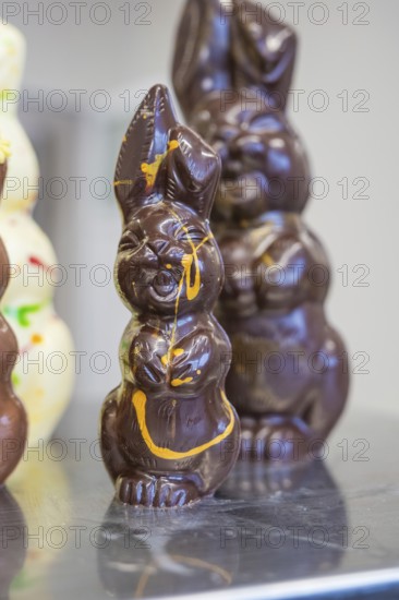 Close-up of a dark-colored chocolate bunny with decoration, Easter production of regional products, Haselstaller Hof, Gechingen, Calw district, Germany