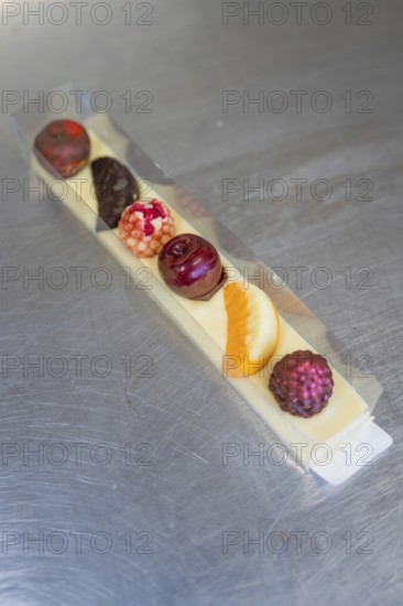 Various chocolates in a transparent gift box on a metal surface, Easter production of regional products, Haselstaller Hof, Gechingen, Calw district, Germany