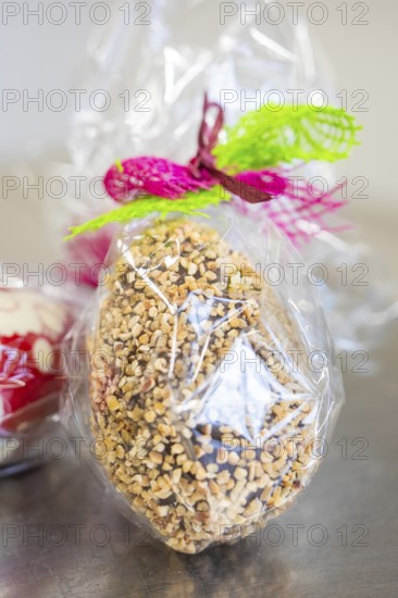 Chocolate decorated with colorful ribbon with nuts in cellophane, Easter production of regional products, Haselstaller Hof, Gechingen, Calw district, Germany