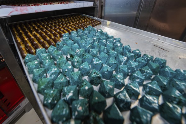 Blue geometric chocolates with shiny surface in rank and file, Easter production of regional products, Haselstaller Hof, Gechingen, Calw district, Germany