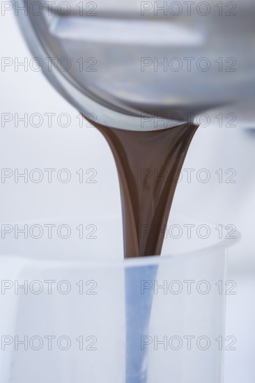 Liquid chocolate is poured into a container, Vegan Tart Production, Haselstaller Hof, Gechingen, Germany