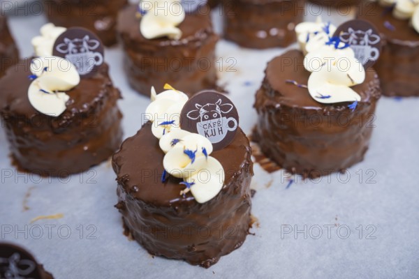 Close-up of chocolate tarts with cream and café logo, vegan cake production, Haselstaller Hof, Gechingen, Germany