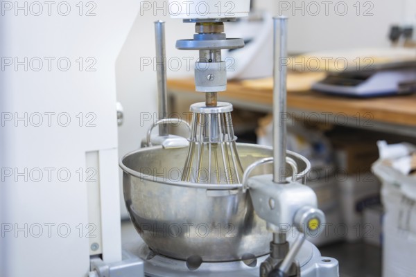 An industrial kitchen mixer with a large metal mixing container in a bakery, vegan cake production, Haselstaller Hof, Gechingen, Germany