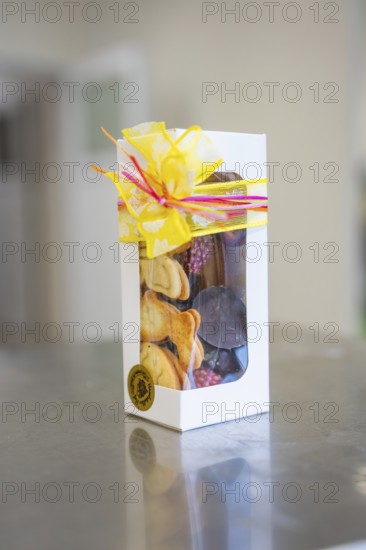 Elegant gift box decorated with chocolates and a yellow bow, Easter production of regional products, Haselstaller Hof, Gechingen, Calw district, Germany