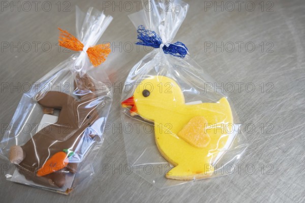 Yellow duck cookie and brown rabbit cookie, both wrapped in foil with colorful ribbons, Easter production of regional products, Haselstaller Hof, Gechingen, Calw district, Germany