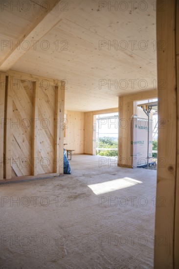 Interior view of a wooden building under construction with large amounts of light, timber house construction, Gechingen, Germany