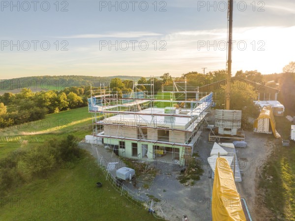 Building construction in a natural environment with crane and scaffolding, timber house construction, Gechingen, Germany
