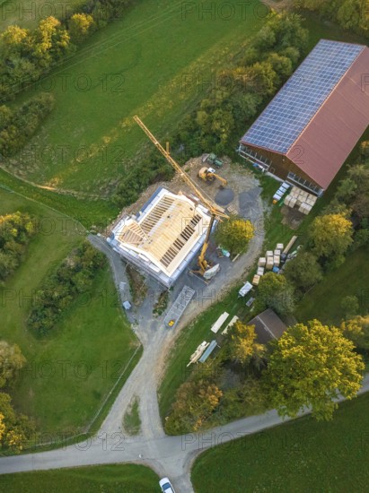 View from above of a construction site next to a building with solar panel on the roof, timber house construction, Gechingen, Germany