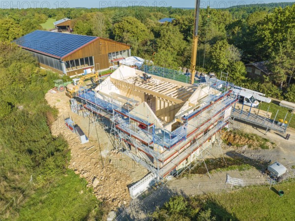 Bird's eye view of a construction site in a natural environment with solar building nearby, timber house construction, Gechingen, Germany