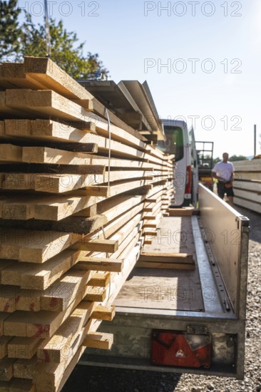 Wood planks on a transport vehicle in sunlight, prepared for construction, timber house construction, Gechingen, Germany